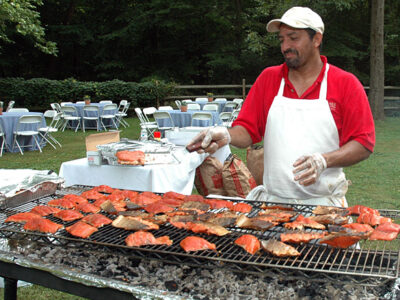 Grilling salmon at catered event
