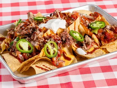 Ballpark nachos served with pico de gallo, cheese, jalapenos, sour cream, Rocklands sweet & smoky sauce, and chopped pork