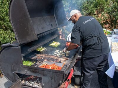 Rocklands Catering team member grilling outside at event