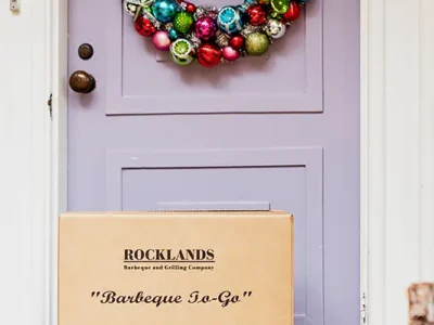 Rocklands boxes in front of a door decorated with holiday wreath