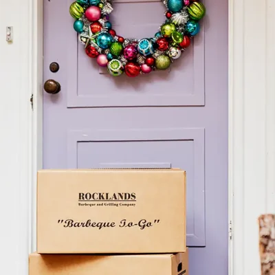 Rocklands boxes in front of a door decorated with holiday wreath