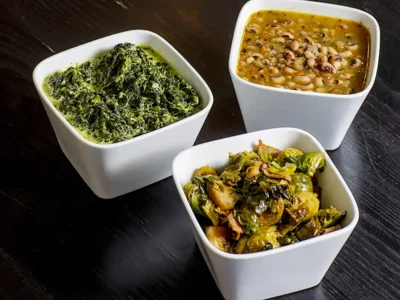 Three Rocklands side dishes of creamed spinach, black beans and Brussels sprouts